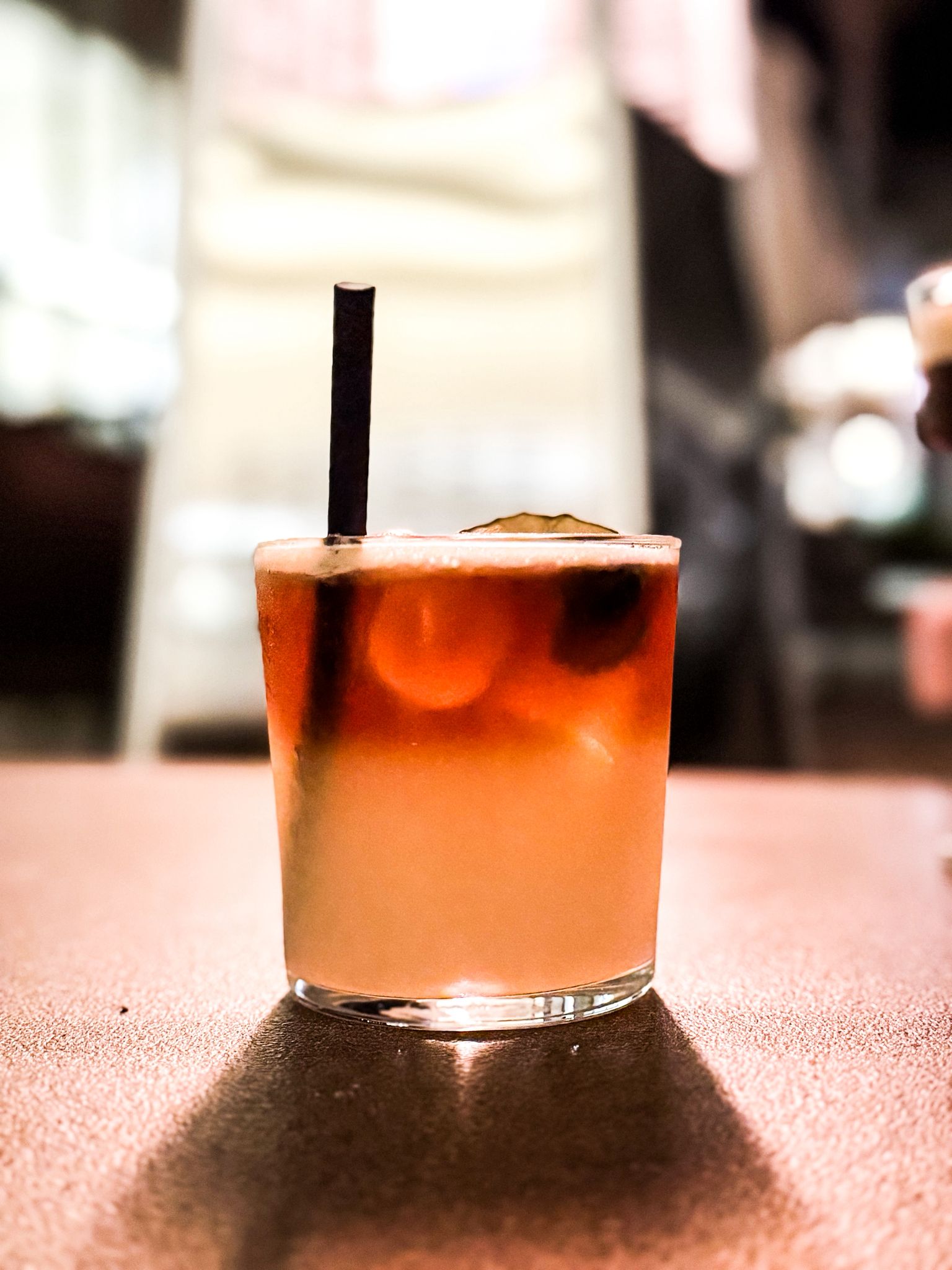 Lifestyle shot of a cocktail in Mélia Durres Albania. The cocktail takes center stage, using the light to give a luxury feel