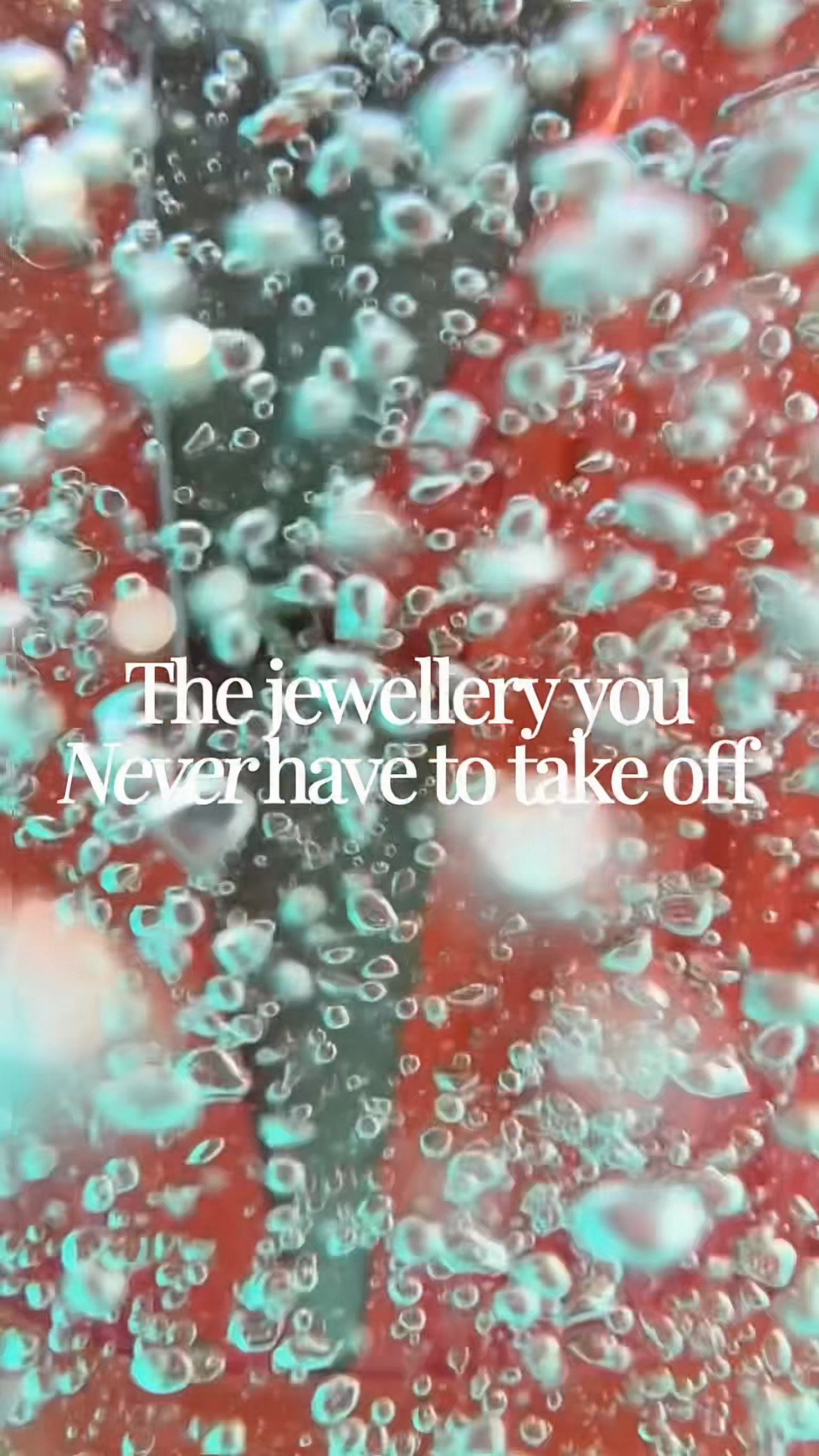 Textured air bubbles suspended in water over a warm red background, creating a soft and immersive mood.