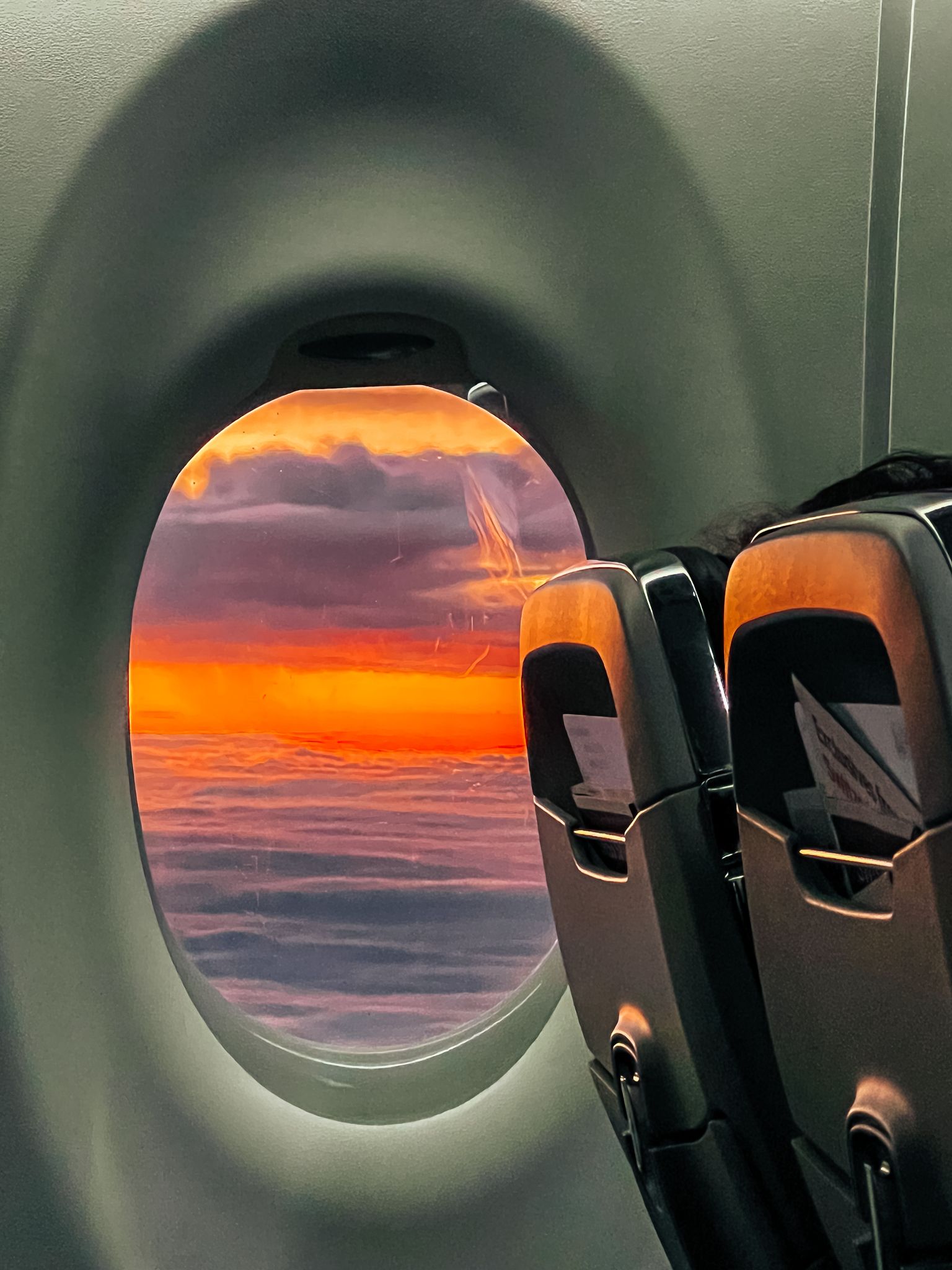 The sunset seen through a plane window.