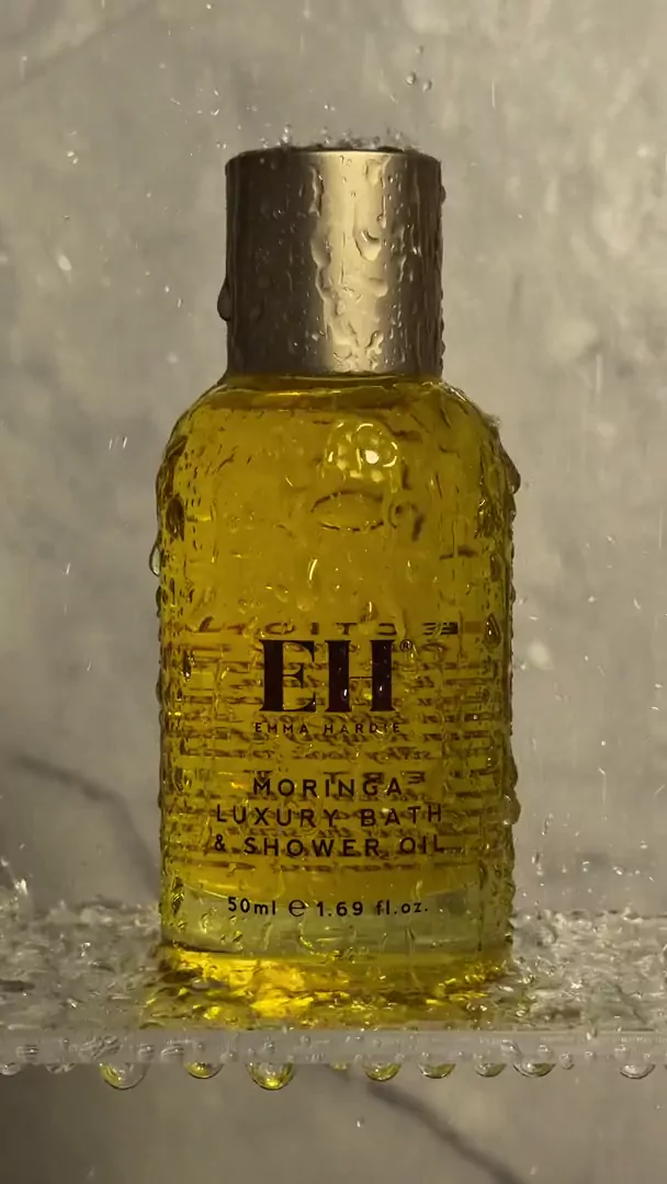 Emma Hardie Moringa Luxury Bath & Shower Oil under running water in an editorial body ritual reel by Beauty With Ju
