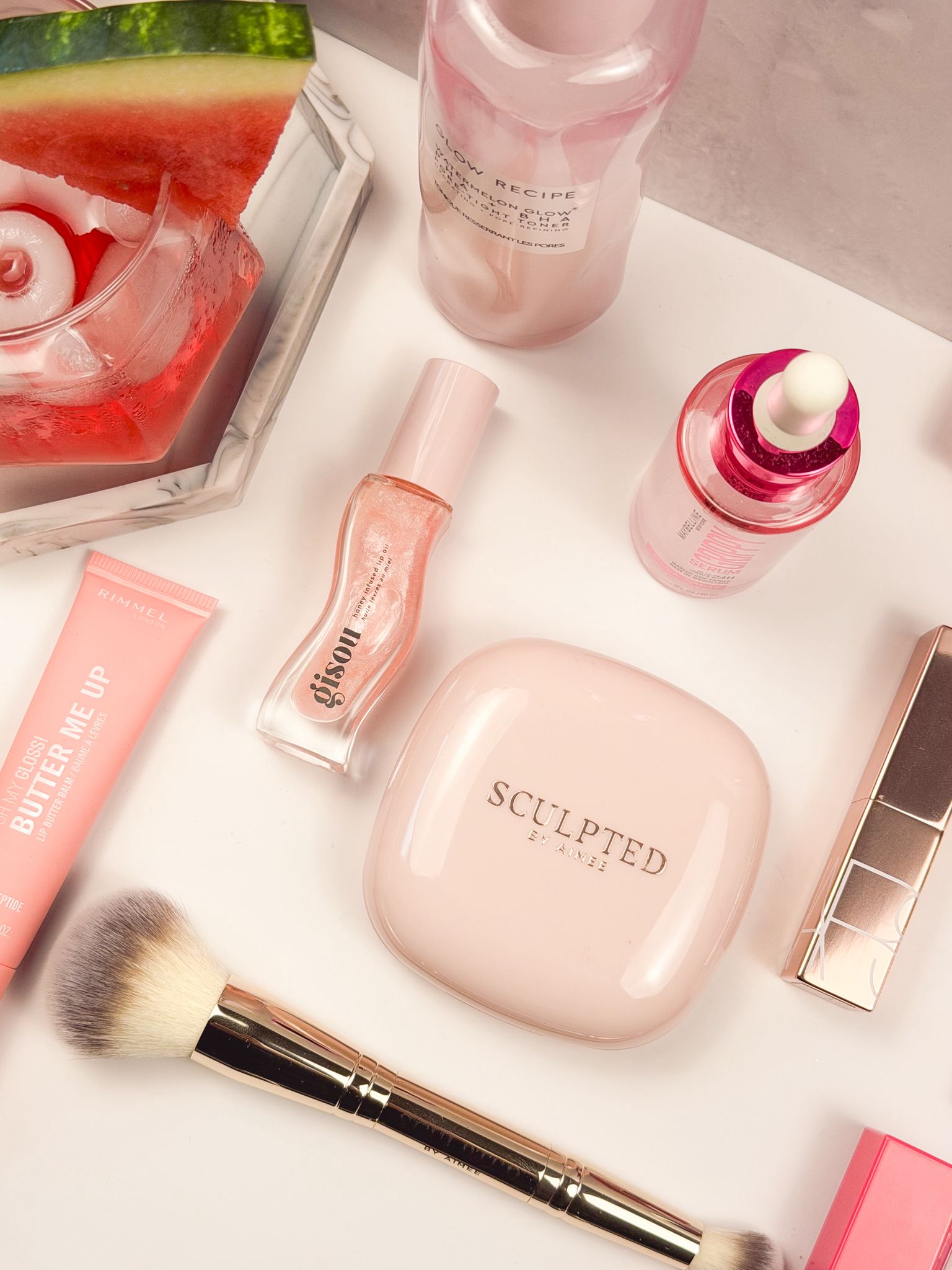 Pink-themed beauty favorites vanity edit featuring Sculpted By Aimee, Gisou Lip Oil, Glow Recipe, YSL, Clarins and other
